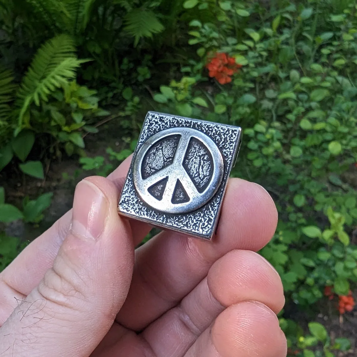 Peace symbol molle clip from bronze