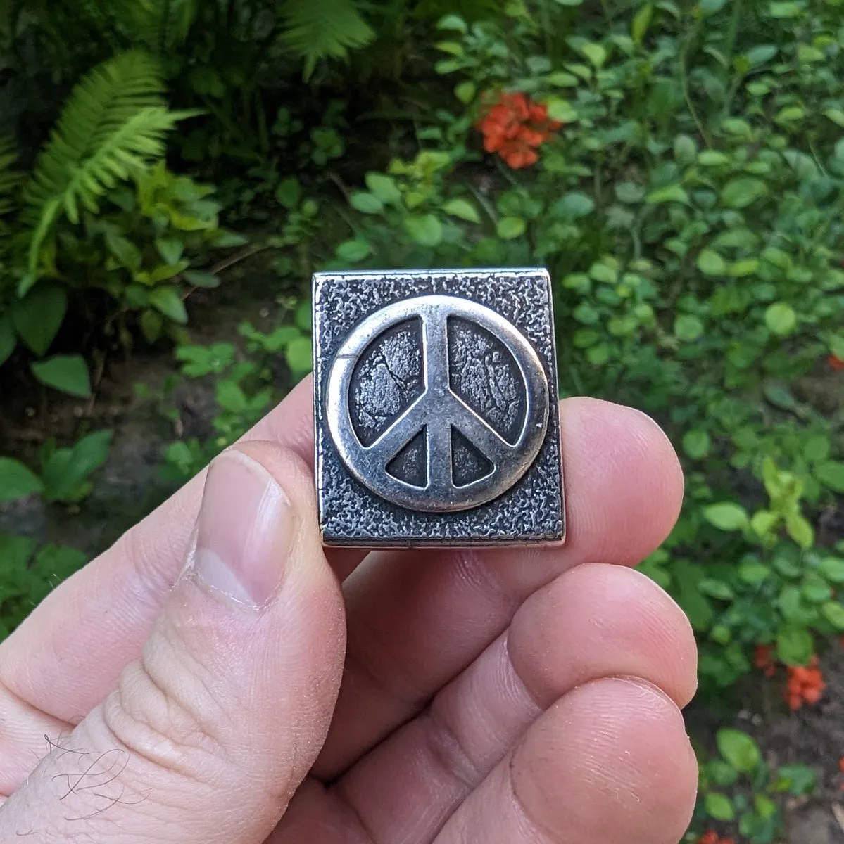 Peace symbol molle clip from bronze