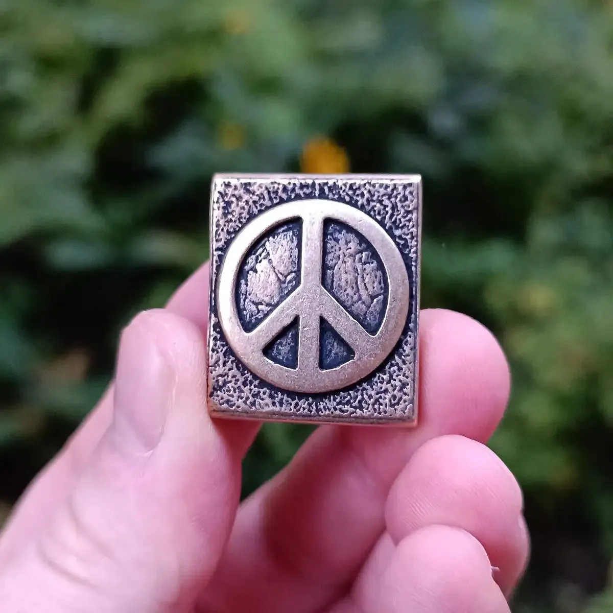 Peace symbol molle clip from bronze