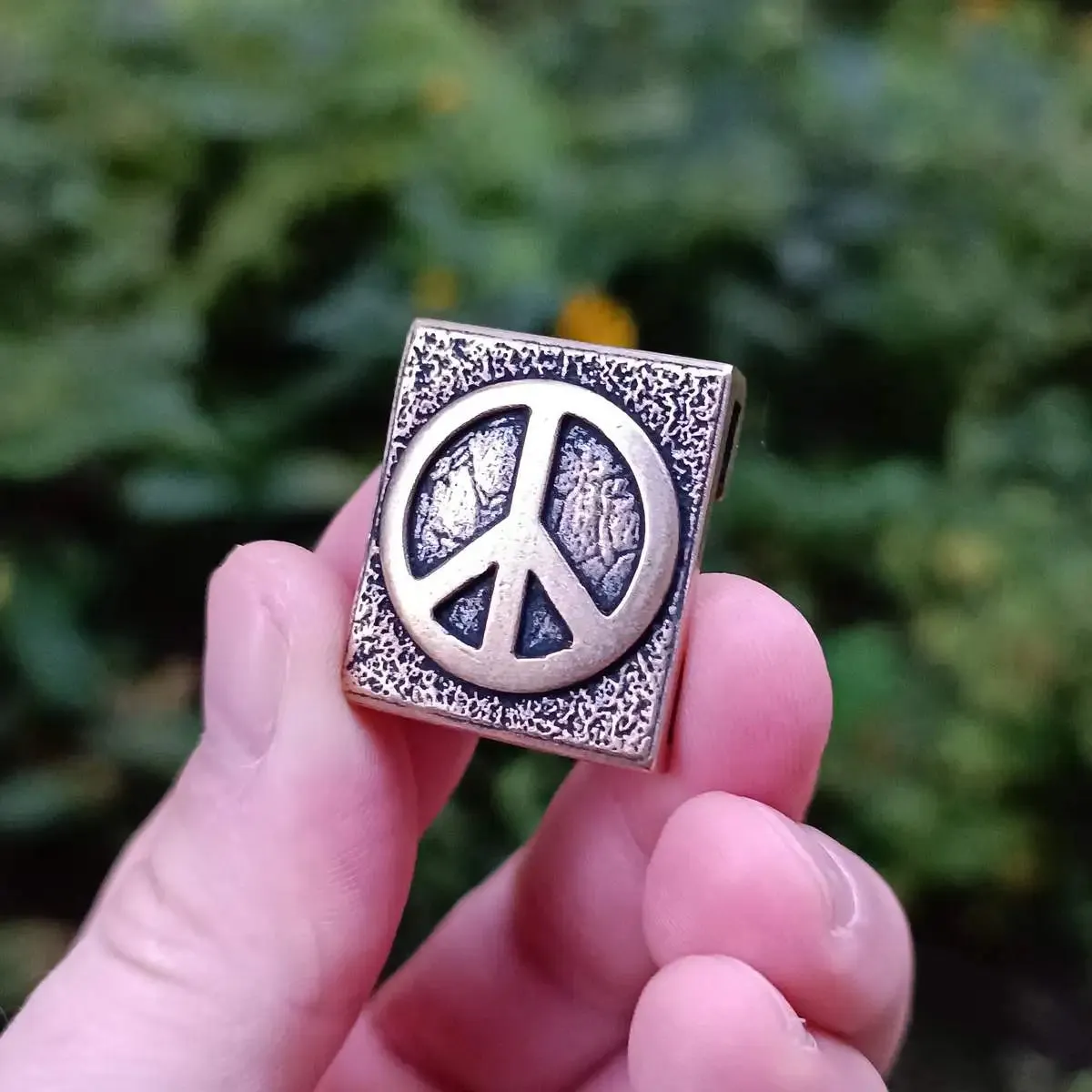 Peace symbol molle clip from bronze